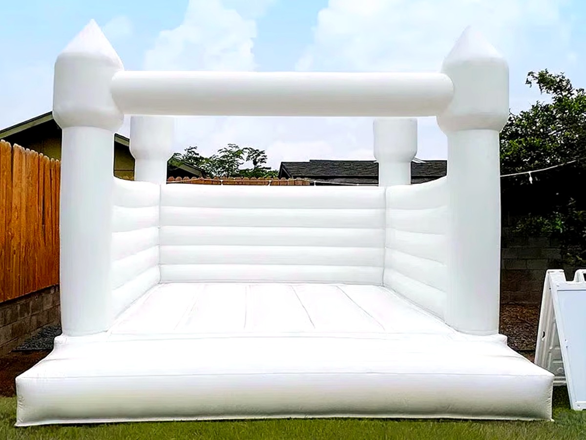 The Hartwell Classic, a timeless all-white castle bounce house with a bishop-top peak and a large open bounce area