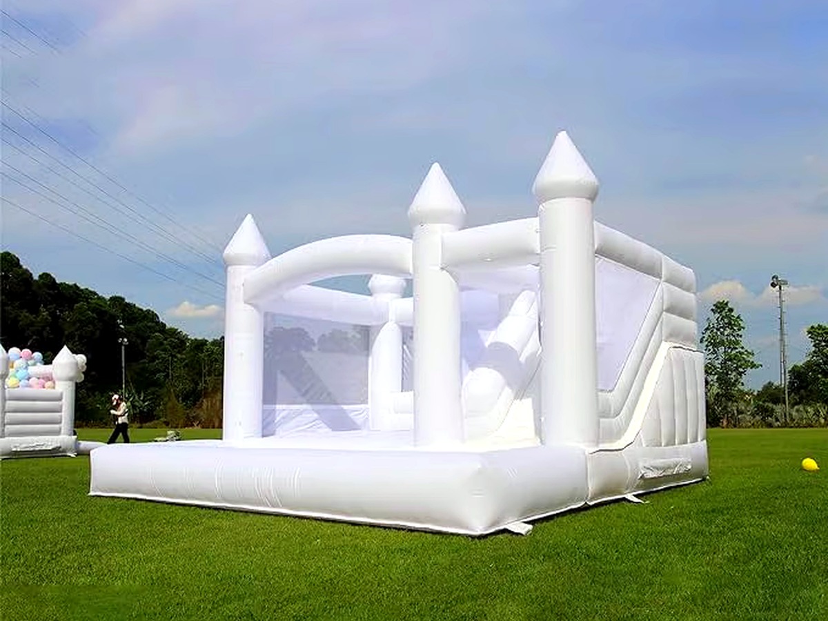The Hartwell Grand, the largest all-white combination castle bounce house with a bishop-top peak, built-in slide, and ball pit
